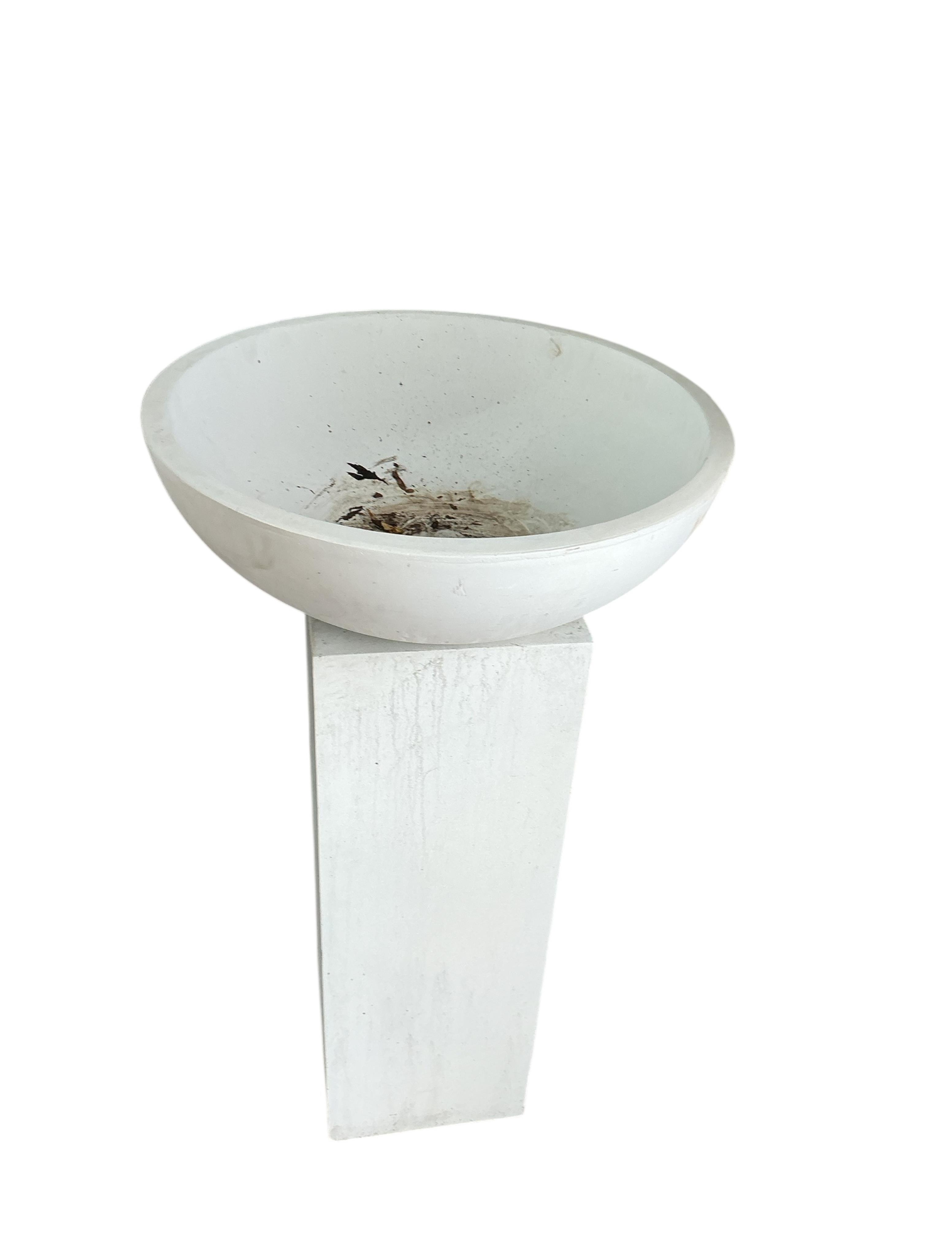 A pair of contemporary circular composition planters on square pedestal bases, diameter 60cm, height 112cm